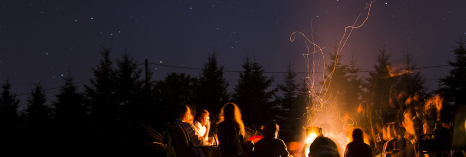 A group of campers sitting around a campfire